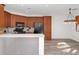 Bright kitchen showcasing wood cabinets, black appliances, and a dining area with modern lighting at 13587 W Cypress St, Goodyear, AZ 85395