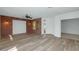 Spacious living room with brick accent wall, neutral flooring, and ample natural light from multiple windows at 13587 W Cypress St, Goodyear, AZ 85395
