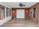 Well-lit living space with stylish flooring, a brick feature wall, and views to the outside through large windows at 13587 W Cypress St, Goodyear, AZ 85395