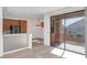 Open-concept room featuring gray wood floors and a sliding glass door that leads outside at 13587 W Cypress St, Goodyear, AZ 85395