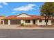 Inviting single-story home with a red tile roof, desert landscaping, and a large three-car garage at 15811 N 60Th Way, Scottsdale, AZ 85254