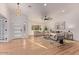 Bright living room featuring wood floors, modern decor, and a large window with natural light at 15811 N 60Th Way, Scottsdale, AZ 85254