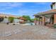 Backyard showcasing a pool, covered patio, outdoor dining area, mature trees, and landscaping at 1721 E Mallory St, Mesa, AZ 85203