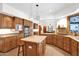 Spacious kitchen featuring wooden cabinets, a central island with butcher block, and stainless steel appliances at 1721 E Mallory St, Mesa, AZ 85203