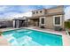 A private backyard featuring a pool and cabana, surrounded by lush greenery at 17263 N Bala Dr, Maricopa, AZ 85138