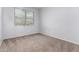 Sunlit bedroom with soft carpeting and a large window, creating a cozy and inviting space at 17263 N Bala Dr, Maricopa, AZ 85138
