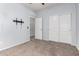 Bedroom features a closet with double doors, ceiling fan, a tv mount and carpet flooring at 17263 N Bala Dr, Maricopa, AZ 85138