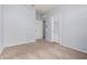 A cozy bedroom with neutral walls, carpet, and two doors offering plenty of options at 17263 N Bala Dr, Maricopa, AZ 85138