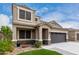 Charming home with vibrant greenery, complemented by a convenient attached two-car garage at 17263 N Bala Dr, Maricopa, AZ 85138