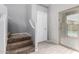 Bright hallway featuring stairs, tile floors, and sliding glass door to the backyard at 17263 N Bala Dr, Maricopa, AZ 85138