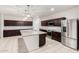 Spacious kitchen featuring stainless steel appliances, a large island, granite countertops, and ample cabinet space at 17263 N Bala Dr, Maricopa, AZ 85138