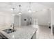 Bright, modern kitchen with a large granite island, stainless steel appliances, and an open floorplan at 17263 N Bala Dr, Maricopa, AZ 85138
