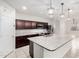 Well-lit kitchen with granite countertops, stainless steel appliances, dark cabinets, and pendant lighting at 17263 N Bala Dr, Maricopa, AZ 85138