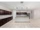 Modern kitchen featuring dark wood cabinets, granite countertops, stainless steel appliances, and tile flooring at 17263 N Bala Dr, Maricopa, AZ 85138