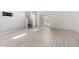 Spacious living room with tile floors, stairway, and sliding glass door to the backyard at 17263 N Bala Dr, Maricopa, AZ 85138
