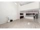 Bright living room with an open layout, leading into a kitchen with stainless steel appliances and granite countertops at 17263 N Bala Dr, Maricopa, AZ 85138