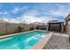 A clear pool with a relaxing cabana, complemented by an inviting patio area at 17263 N Bala Dr, Maricopa, AZ 85138