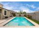 A backyard pool offers a refreshing escape, complemented by lush landscaping and serene privacy at 17263 N Bala Dr, Maricopa, AZ 85138