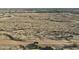 An aerial view of a neighborhood showing a new construction site surrounded by desert vegetation at 20179 W Highland Ave, Litchfield Park, AZ 85340
