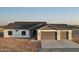 Charming single-story home featuring a three-car garage and a modern, neutral color scheme in a desert environment at 20179 W Highland Ave, Litchfield Park, AZ 85340