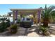 Outdoor spa under pergola is surrounded by beautiful desert landscaping at 21047 N Alma Dr, Maricopa, AZ 85138