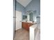 Charming bathroom offers double sinks, tiled flooring, and a large mirror at 21047 N Alma Dr, Maricopa, AZ 85138