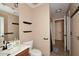 Simple bathroom with dark fixtures, decorative shelving and updated vanity at 21047 N Alma Dr, Maricopa, AZ 85138