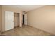Neutral bedroom features tiled floor, closet and easy access to other rooms at 21047 N Alma Dr, Maricopa, AZ 85138