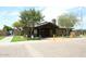 Community center with a welcoming entrance, mature trees, and well-maintained landscaping at 21047 N Alma Dr, Maricopa, AZ 85138