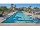 Stunning community pool with lounge chairs and palm trees for a resort-like experience at 21047 N Alma Dr, Maricopa, AZ 85138