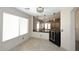 Dining area featuring breakfast bar, pendant lights and view to living area at 21047 N Alma Dr, Maricopa, AZ 85138