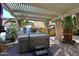 Outdoor hot tub beneath a covered patio, surrounded by lush tropical landscaping at 21047 N Alma Dr, Maricopa, AZ 85138