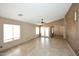 Bright living room with neutral paint, tile flooring, and a view to the backyard at 21047 N Alma Dr, Maricopa, AZ 85138