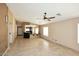 Spacious living room featuring neutral walls, tile flooring, and natural light at 21047 N Alma Dr, Maricopa, AZ 85138