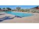 Sparkling community pool with lounge chairs, tables, and shaded seating areas for residents to enjoy at 21047 N Alma Dr, Maricopa, AZ 85138