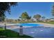 Community splash pad under a clear blue sky, surrounded by grassy areas and mature trees at 21047 N Alma Dr, Maricopa, AZ 85138