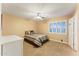 Bright bedroom with a ceiling fan and a large window that lets in natural light at 2106 N Bridlewood --, Mesa, AZ 85207