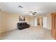 Spacious living room with a brown leather sofa set, neutral carpet, and a ceiling fan for added comfort at 2106 N Bridlewood --, Mesa, AZ 85207