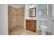 Bathroom features a tile shower with handrails, a vanity, a square mirror, and a toilet at 2214 E Sells Dr, Phoenix, AZ 85016