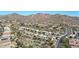 A scenic aerial view showcases a community nestled amongst desert landscape and distant mountains at 28604 N 21St Ln, Phoenix, AZ 85085