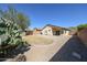 View of backyard featuring gravel, minimal grass and patio area at 28604 N 21St Ln, Phoenix, AZ 85085