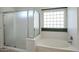 Bathroom featuring a glass enclosed shower and soaking tub at 28604 N 21St Ln, Phoenix, AZ 85085