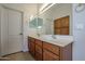 Bathroom features a double sink vanity and built-in wooden cabinets at 28604 N 21St Ln, Phoenix, AZ 85085