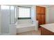 Bright bathroom with separate tub and glass enclosed shower at 28604 N 21St Ln, Phoenix, AZ 85085