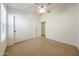 Bedroom with neutral carpet, ceiling fan, and closet doors offering ample storage space at 28604 N 21St Ln, Phoenix, AZ 85085