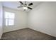Cozy bedroom with carpet flooring, natural light, and a ceiling fan at 28604 N 21St Ln, Phoenix, AZ 85085