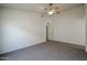 Neutral bedroom featuring carpeted floors, a ceiling fan, and closet at 28604 N 21St Ln, Phoenix, AZ 85085