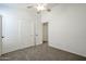 Bedroom featuring carpeted floors, a ceiling fan, and closet and door at 28604 N 21St Ln, Phoenix, AZ 85085