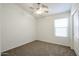 Well-lit bedroom with neutral walls, carpet floors, and a view of outside at 28604 N 21St Ln, Phoenix, AZ 85085