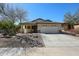 Charming single-story home with a two car garage, xeriscape landscaping, and neutral color palette at 28604 N 21St Ln, Phoenix, AZ 85085